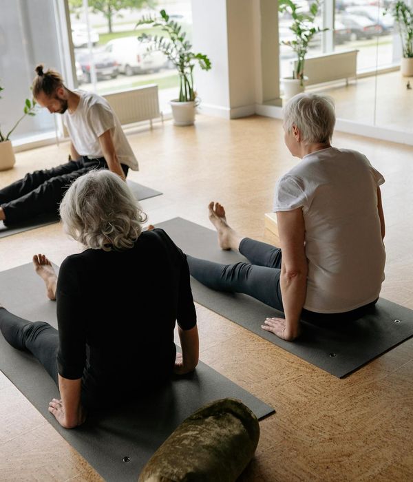 Woman performing a fluid yoga sequence in a calm environment.
